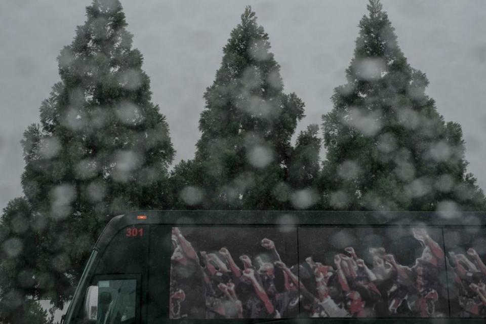 Through the rain, members of Black Voters Matter meet early at a BJ's in Atlanta, Ga. before heading to Columbus to take voters to the polls on election day, Nov. 6, 2018.