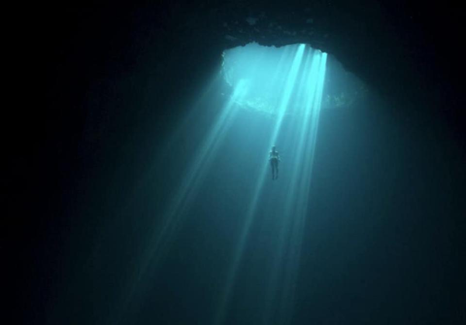 Person swimming up to opening in water