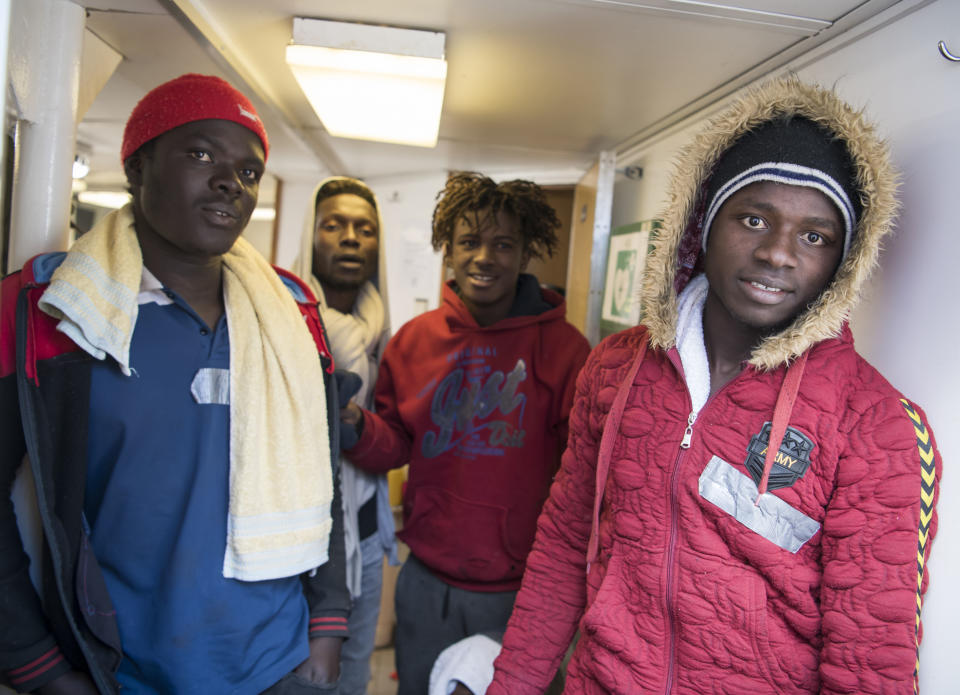 Some of the 17 people rescued in the Mediterranean Sea wait aboard the German rescue ship Sea-Eye afloat off Malta, Tuesday, Jan. 8, 2019. Two German nonprofit groups appealed to European Union countries Tuesday to take in 49 migrants who are stuck on rescue ships in the Mediterranean Sea, warning of the passengers' deteriorating health. (AP Photo/Rene Rossignaud)