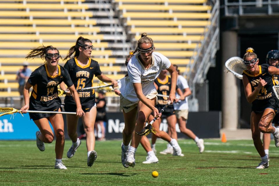 New Albany's Abby Cole chases for the ball ahead of Upper Arlington's Ella Devine (14), Viv Lawless (15) and Abbie Dunlap (24) during the state championship game.