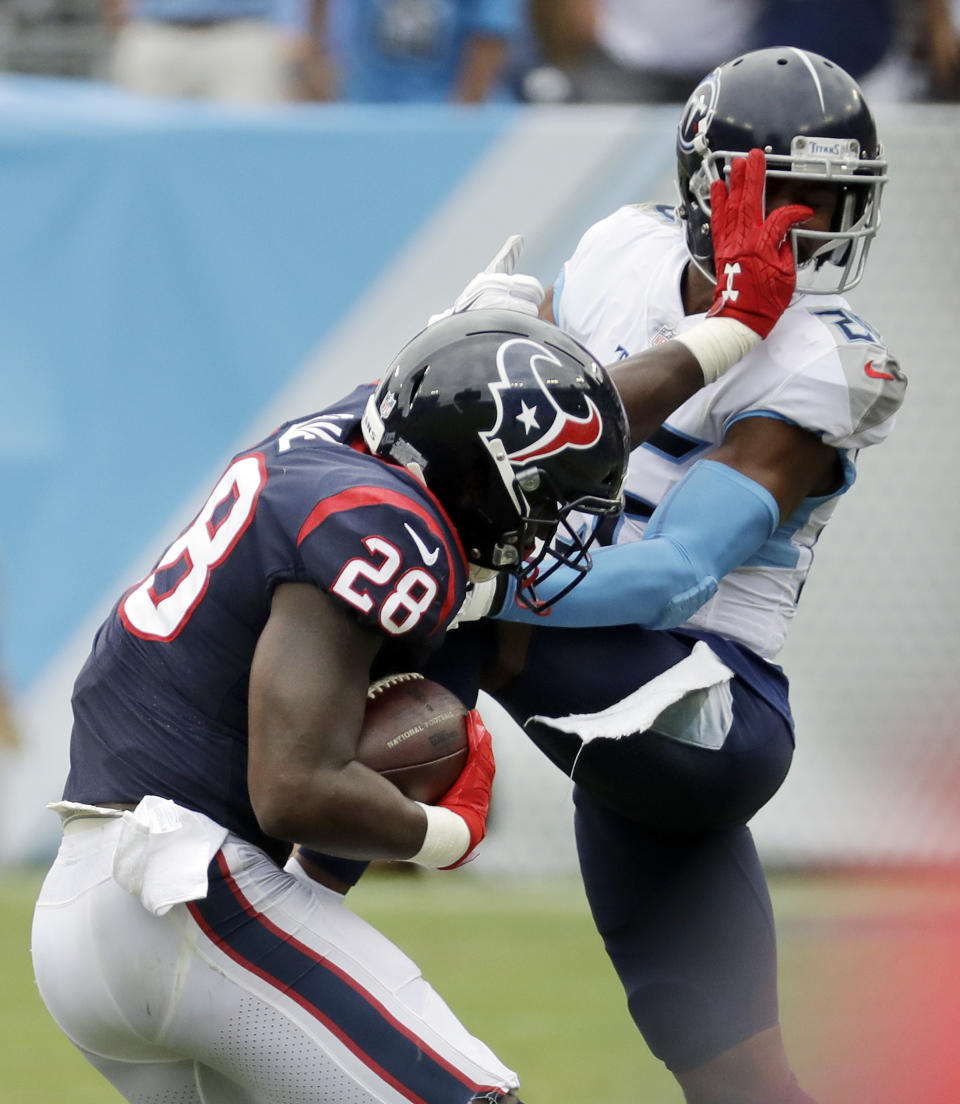 Houston Texans running back Alfred Blue (28) tries to get past Tennessee Titans defensive back Logan Ryan in the second half of an NFL football game Sunday, Sept. 16, 2018, in Nashville, Tenn. (AP Photo/James Kenney)