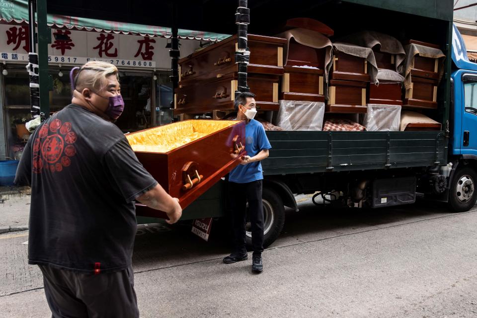 Empty coffins are delivered to a funeral services shop and funeral parlours in the Kowloon district of Hong Kong on March 17, 2022. - A funeral industry representative on March 16 told local media the soaring death toll due to Covid-19 had seen a crunch in the city's coffins supply, with only 300 remaining and expected to be gone by the weekend. (Photo by ISAAC LAWRENCE / AFP) (Photo by ISAAC LAWRENCE/AFP via Getty Images)