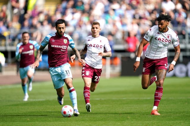 Burnley’s Dwight McNeil, left, runs at the Aston Villa defence