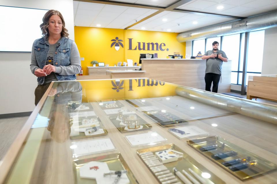 General manager Laura Merritt looks over the marijuana products on display at Lume Cannabis Co. dispensary, one of its 38 Michigan locations.