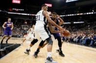 Phoenix Suns power forward Markieff Morris (R) is defended by San Antonio Spurs power forward Tim Duncan (21) during the second half at AT&T Center. Mandatory Credit: Soobum Im-USA TODAY Sports