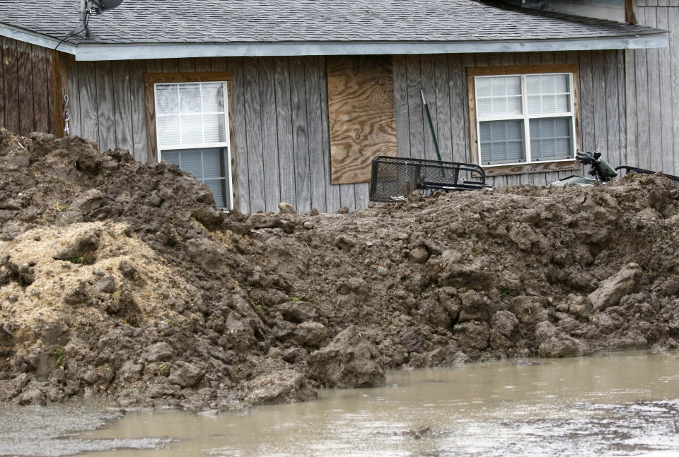 This March 11, 2019 photo shows a makeshift levee built by a resident in Rolling Fork, Miss., to protect his home from flood waters. In March 2019, scientists are warning that historic flooding could soon deluge parts of several southern states along the lower Mississippi River, where flood waters could persist for several weeks. (AP Photo/Rogelio V. Solis)