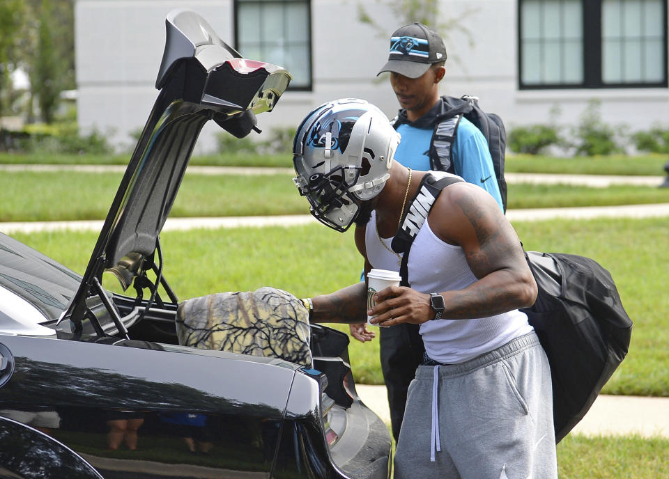 Carolina Panthers linebacker Denzel Perryman wears his football helmet as he unpacks at NFL football training camp, Tuesday, July 27, 2021, at Wofford College in Spartanburg, S.C. (Jeff Siner/The Charlotte Observer via AP)