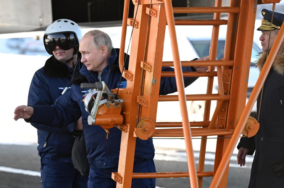 Russian President Vladimir Putin, foreground, boards a Tu-160M strategic bomber in Kazan, Russia, Thursday, Feb. 22, 2024. (Dmitry Azarov, Sputnik, Kremlin Pool Photo via AP)