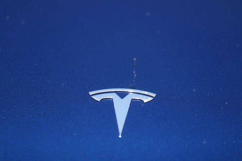 FILE PHOTO: The Tesla logo is seen on a car in Los Angeles