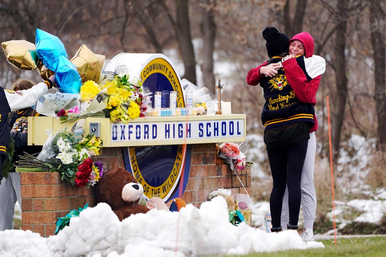 Students hug at a memorial at Oxford High School in Oxford, Mich., Dec. 1. 