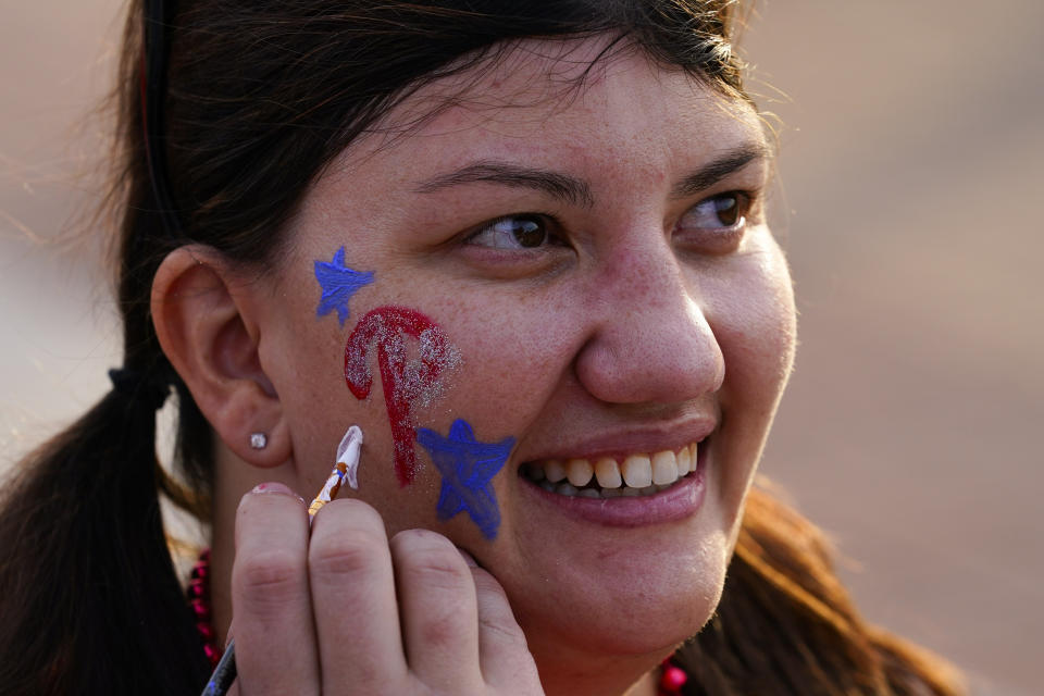 A fan gets her face painted before Game 4 of baseball's World Series between the Houston Astros and the Philadelphia Phillies on Wednesday, Nov. 2, 2022, in Philadelphia. (AP Photo/Matt Rourke)