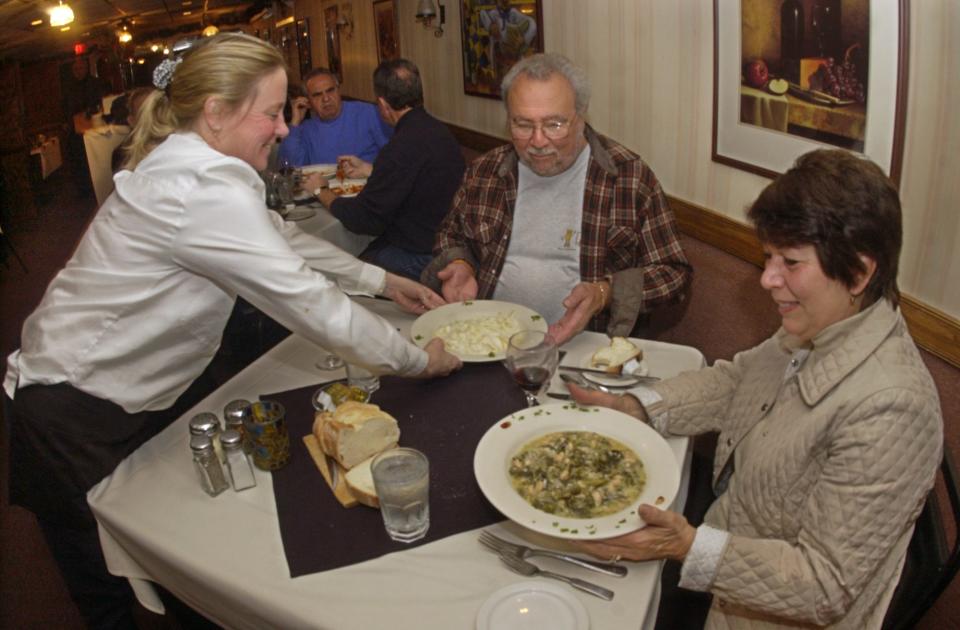 Martha Farabel serves up a lunch of greens and beans and fettucine alfredo to Linda and Joe LaTempa at the popular Dentico's Italian Villa in Rochester on Nov. 5, 2007.