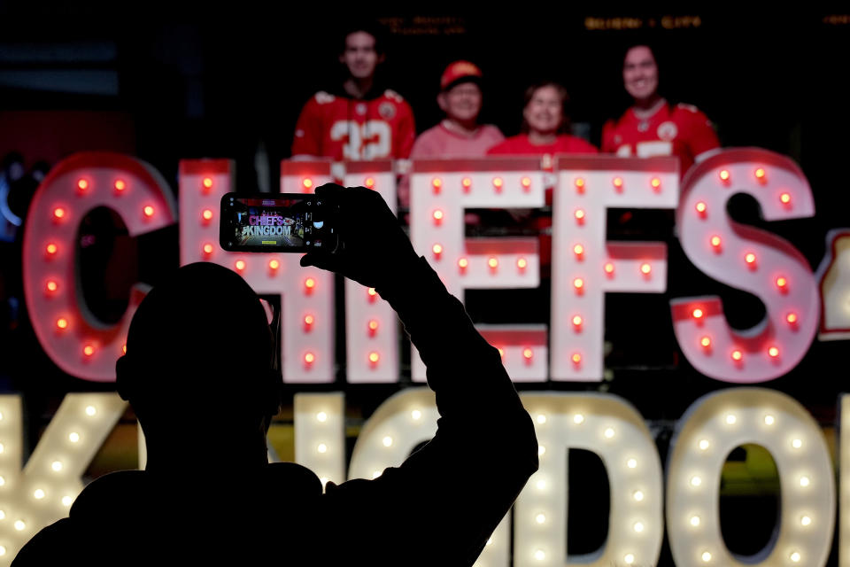 People have their photo taken with signage for the Kansas City Chiefs NFL football team while visiting a display Thursday, Feb. 9, 2023, at Union Station in Kansas City, Mo. The Chiefs are scheduled to play the Philadelphia Eagles in Super Bowl LVII on Sunday, Feb. 12, 2023. (AP Photo/Charlie Riedel)