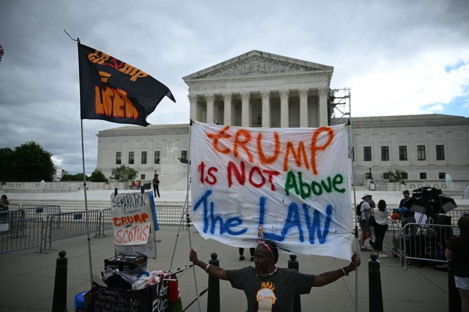 People protest outside the Supreme Court on July 1, 2024, ahead of the court’s anticipated decision on whether Donald Trump is immune from prosecution. <a href="https://www.gettyimages.com/detail/news-photo/people-hold-anti-trump-signs-in-front-of-the-us-supreme-news-photo/2159549929?adppopup=true" rel="nofollow noopener" target="_blank" data-ylk="slk:Drew Angerer/AFP via Getty Images;elm:context_link;itc:0;sec:content-canvas" class="link ">Drew Angerer/AFP via Getty Images</a>