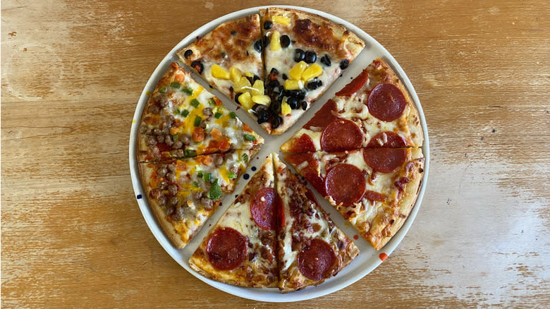 assorted pizza slices on plate