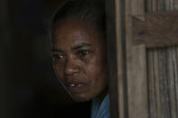 In this Oct. 22, 2018, photo, Margarita Oematan, grandmother of Orance Faot, looks out of her home in O'of Village in West Timor, Indonesia. Orance's family says she was lured from their house by her own cousin, and is believed to have been trafficked to Malaysia. Her family has not heard from her in four years. (AP Photo/Tatan Syuflana)