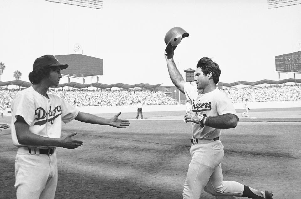 FILE - Los Angeles Dodgers Steve Garvey, right, waves his batting cap to the crowd after hitting a home run in the sixth inning in Game 4 of the National League playoffs in Los Angeles, Oct. 7, 1978. The candidacy for the U.S. Senate of former California baseball star Garvey has brought a splash of celebrity to the race that has alarmed his Democratic rivals and tugged at the state's political gravity.(AP Photo/File)