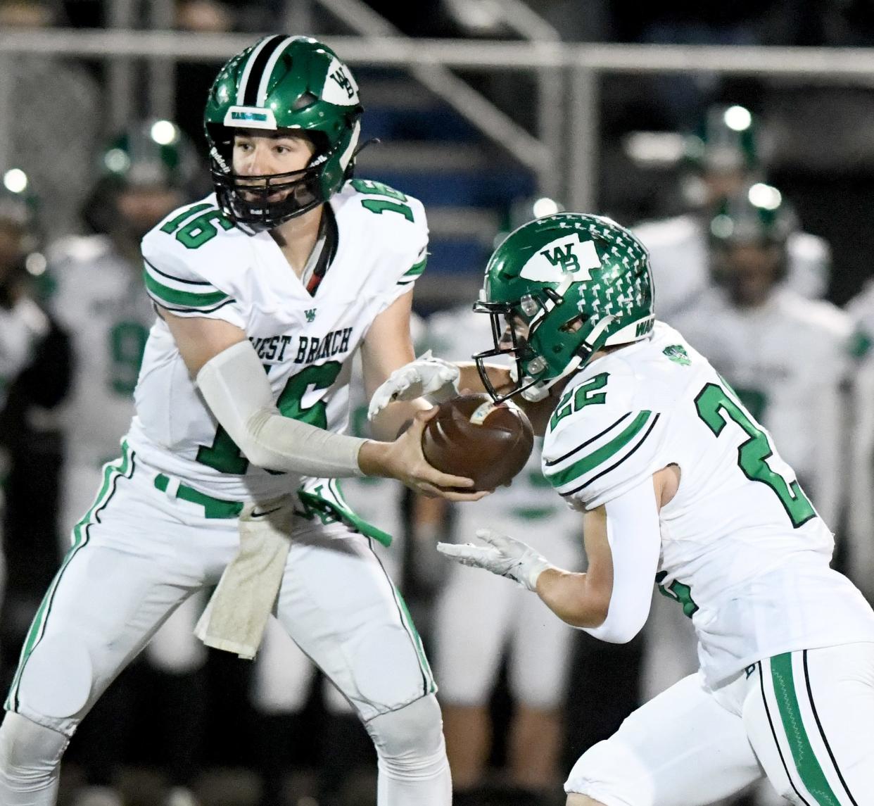 West Branch quarterback Beau Alazaus hands the ball to running back Boston Mulinix against Canton South in a Division IV regional semifinal at Louisville Leopard Stadium. Friday, Nov. 10, 2023.