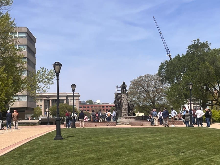 Workers outside of the capitol wait outside while the building is evacuated.