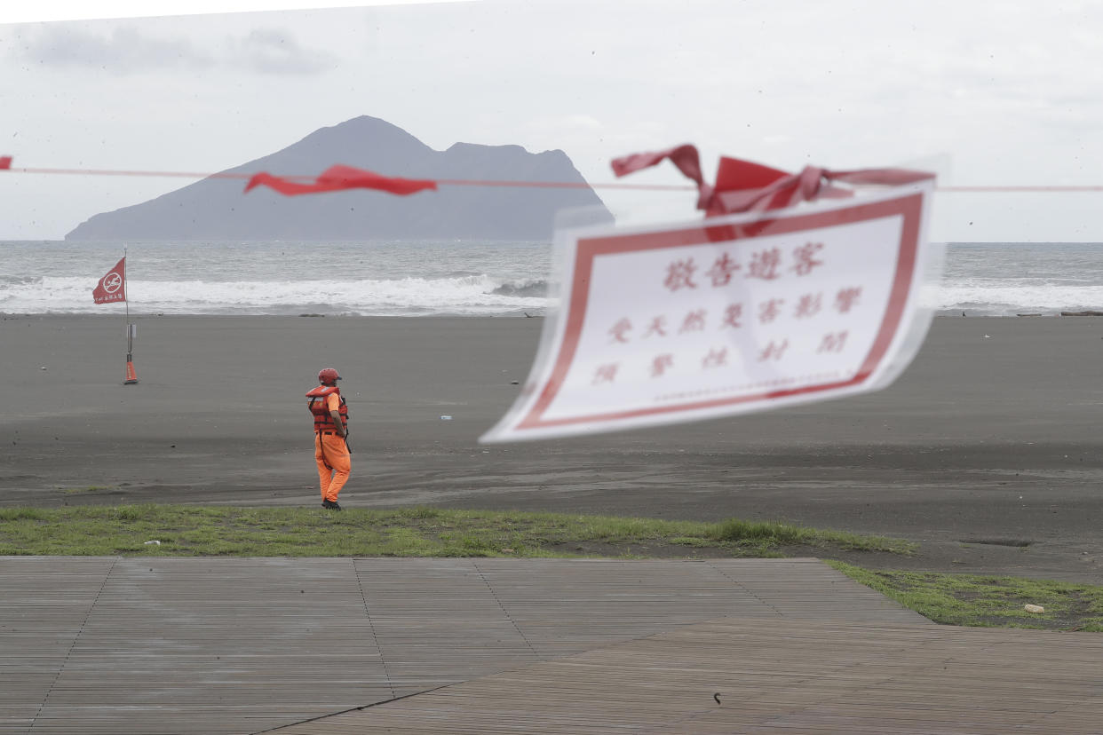 A soldier of Coast Guard Administration guards on the beach as Typhoon Krathon approaches to Taiwan in Yilan County, eastern coast of Taiwan, Tuesday, Oct. 1, 2024. (AP Photo/Chiang Ying-ying)