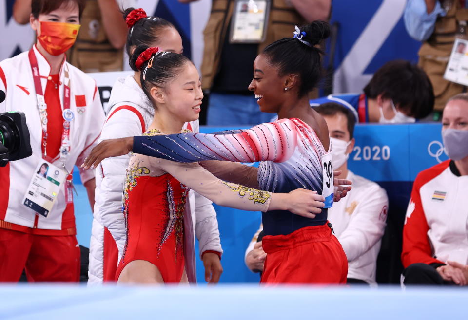 Tokyo 2020 Olympics - Gymnastics - Artistic - Women's Beam - Final - Ariake Gymnastics Centre, Tokyo, Japan - August 3, 2021. Simone Biles of the United States congratulates Guan Chenchen of China after competing REUTERS/Mike Blake    SEARCH 