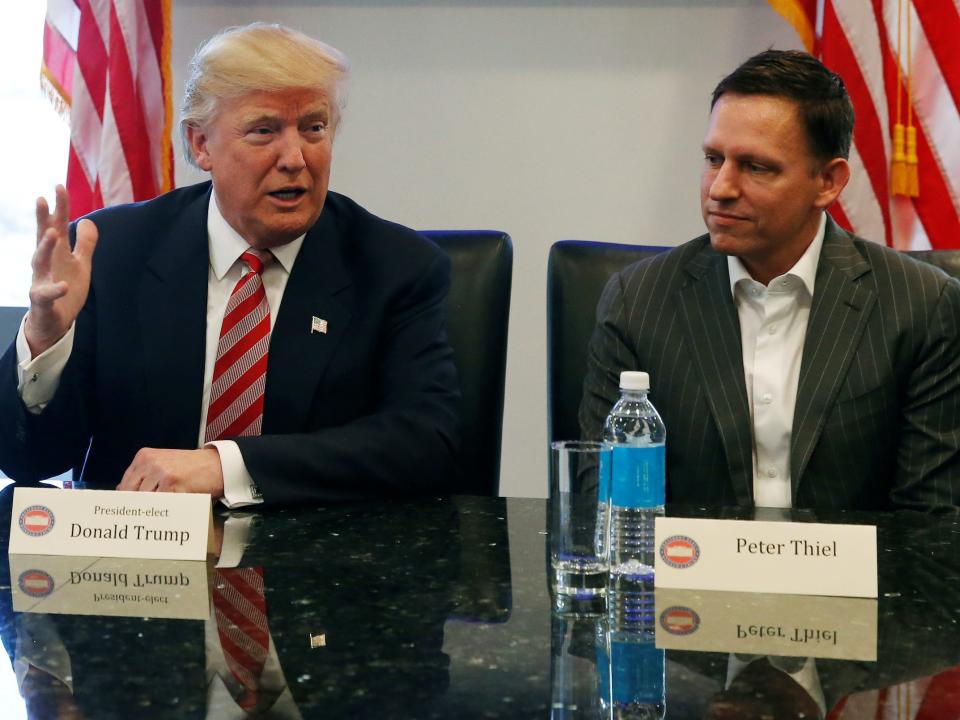 Peter Thiel (right) and Donald Trump (right) sitting next to each other.