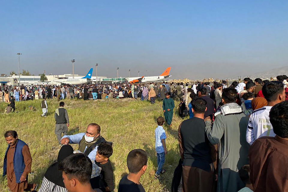 Afghans crowd at the airport as they wait to leave from Kabul on August 16, 2021. (Photo by Shakib Rahmani / AFP) (Photo by SHAKIB RAHMANI/AFP via Getty Images)