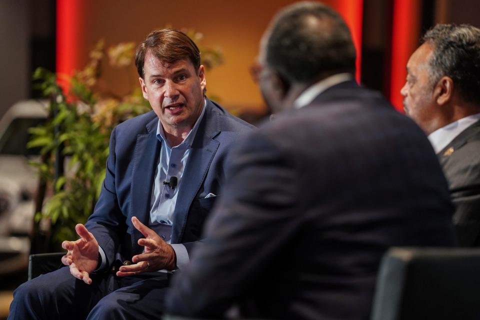 Ford CEO Jim Farley, left, speaks with the Rev. Jessie Jackson, right, and Rainbow PUSH/CEF Automotive Project Chairman John A. Graves as part of a fireside chat during the 23rd Annual Rainbow PUSH Global Automotive Summit at Motor City Casino on Nov. 15, 2022, in Detroit.