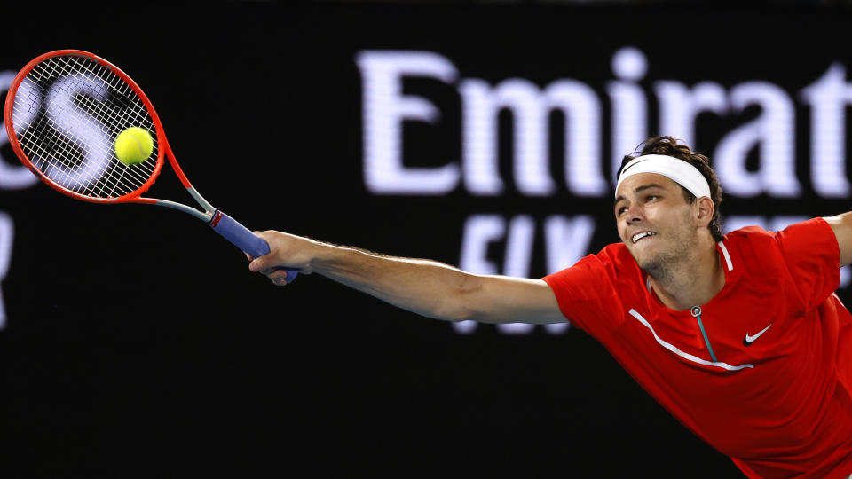 Taylor Fritz of the U.S. makes a forehand return to Stefanos Tsitsipas of Greece during their fourth round match at the Australian Open tennis championships in Melbourne, Australia, Monday, Jan. 24, 2022. (AP Photo/Tertius Pickard)