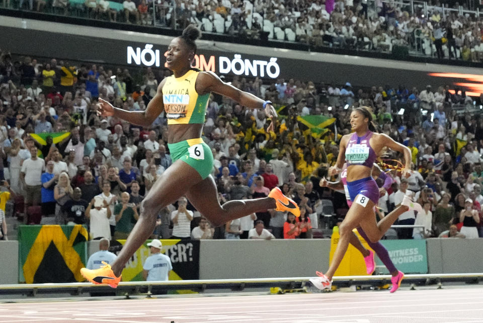 FILE - Shericka Jackson, of Jamaica, crosses the line to win the gold medal ahead of Gabrielle Thomas, of the United States, in the Women's 200-meters final during the World Athletics Championships in Budapest, Hungary, Friday, Aug. 25, 2023. Once again, the hallowed women’s sprint records held by the late Florence Griffith Joyner – 10.49 in the 100 and 21.34 in the 200 – appear to be in jeopardy.(AP Photo/David Phillip, File)
