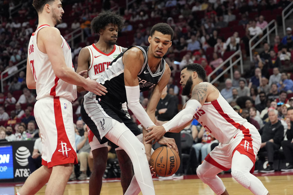 Houston Rockets' Fred VanVleet, right, steels the ball from San Antonio Spurs' Victor Wembanyama during the second half of an NBA basketball game Tuesday, March 5, 2024, in Houston. The Rockets won 114-101. (AP Photo/David J. Phillip)