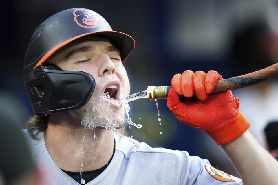 Baltimore Orioles' Gunnar Henderson drinks water as he celebrates after his solo home run during third-inning baseball game action against the Toronto Blue Jays in Toronto, Monday, July 31, 2023. (Nathan Denette/The Canadian Press via AP)