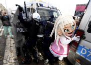 Polish police in riot gear detain protesters, angry over new restrictions aimed at fighting the coronavirus pandemic, in Warsaw, Poland, Saturday, Oct. 24, 2020. The protesters included entrepreneurs, far-right politicians, football fans and vaccine opponents. The clashes come amid rising social tensions and as new restrictions just short of a full lockdown took effect Saturday. (AP Photo/Czarek Sokolowski)