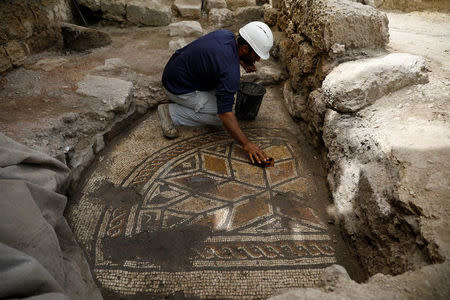 An archaeologist works at a site in the old city of Caesarea , Israel April 26, 2017 REUTERS/Amir Cohen