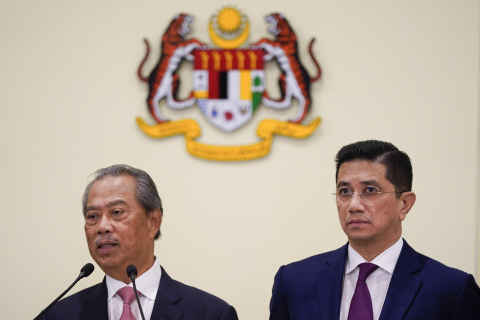 Malaysian new Prime Minister Muhyiddin Yassin, left, speaks next to Senior Minister Azmin Ali during a press conference after the first cabinet meeting at the prime minister's office in Putrajaya, Malaysia Wednesday, March 11, 2020. Yassin said he will form an economic council to find ways to cope with an expected economic slowdown amid the global new coronavirus outbreak. (AP Photo/Vincent Thian)