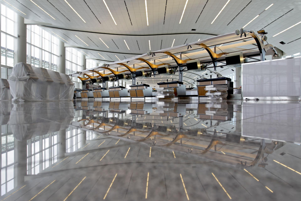 Check-in counters are seen in the entrance to the new Maynard Holbrook Jackson Jr. International Terminal at Atlanta's airport Wednesday, March 28, 2012. The new $1.4 billion international terminal at the world's busiest airport will be a sleek launching pad for millions of passengers that’s designed to help Atlanta grab a growing share of the lucrative market for global travelers. (AP Photo/David Goldman)