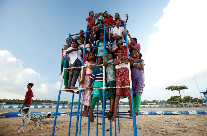 Children staying in the care home set up by Karibeeran Paramesvaran and his wife Choodamani after they lost three children in the 2004 tsunami, pose in a park along a beach in Nagapattinam district in the southern state of Tamil Nadu, India