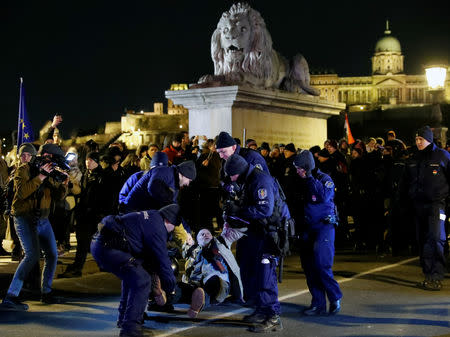 Police officers detain a demonstrator during a protest against a proposed new labor law, billed as the "slave law", in Budapest, Hungary, January 19, 2019. REUTERS/Bernadett Szabo