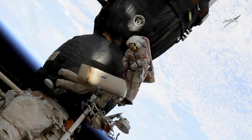 In this image from video made available by NASA, Russian cosmonaut Oleg Kononenko, right, and Sergei Prokopyev perform a spacewalk outside the Soyuz spacecraft attached to the International Space Station on Tuesday, Dec. 11, 2018. They are investigating a section where a mysterious leak appeared on Aug. 30. (NASA via AP)