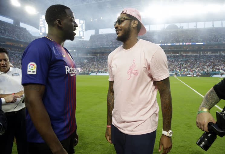 Draymond Green, left, and Carmelo Anthony talk before an International Champions Cup soccer match between Barcelona and Real Madrid on Saturday in Miami Gardens, Florida. (AP)