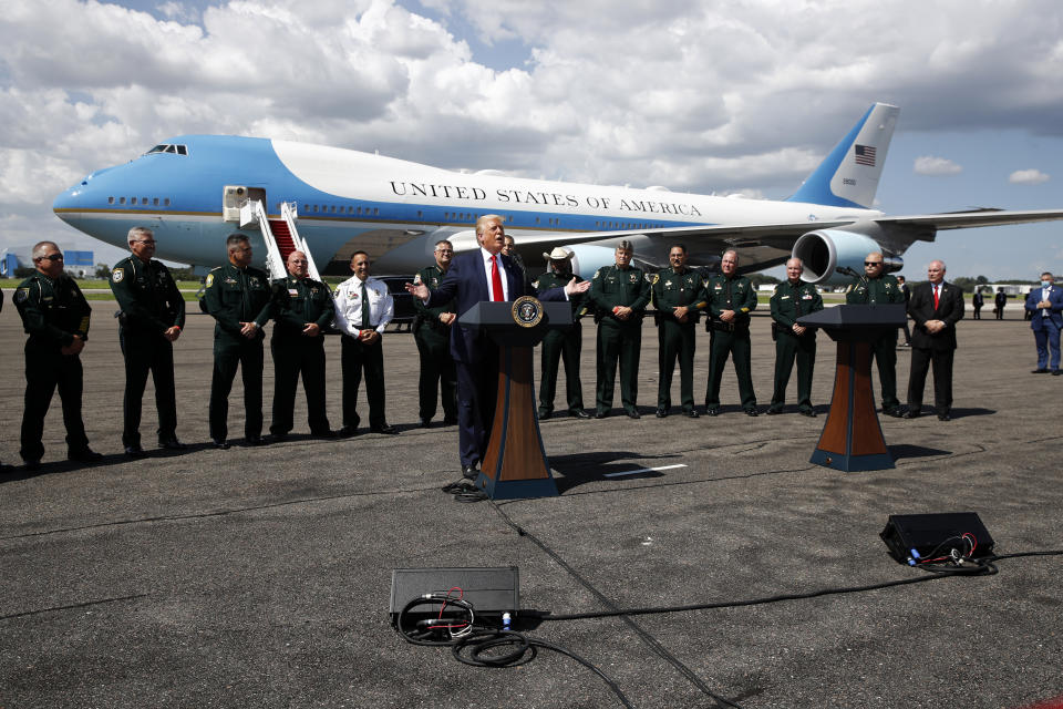 With Air Force One in the background, President Donald Trump speaks during a campaign event with Florida Sheriffs in Tampa, Fla., Friday, July 31, 2020. (AP Photo/Patrick Semansky)