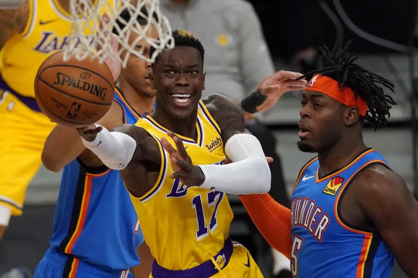 Los Angeles Lakers guard Dennis Schroder, left, shoots as Oklahoma City Thunder forward Luguentz Dort defends during the first half of an NBA basketball game Monday, Feb. 8, 2021, in Los Angeles. (AP Photo/Mark J. Terrill)