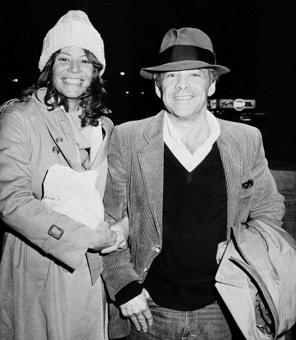 FILE - In this Nov. 28, 1980 file photo, Chuck Barris, host of the television's "Gong Show," and Robin Altman leave the Pierre Hotel in New York. Game show impresario Barris has died at 87. Barris, the madcap producer of "The Gong Show" and "The Dating Game," died of natural causes Tuesday afternoon, March 21, 2017, at his home in Palisades, New York. (AP Photo/Sands, File)