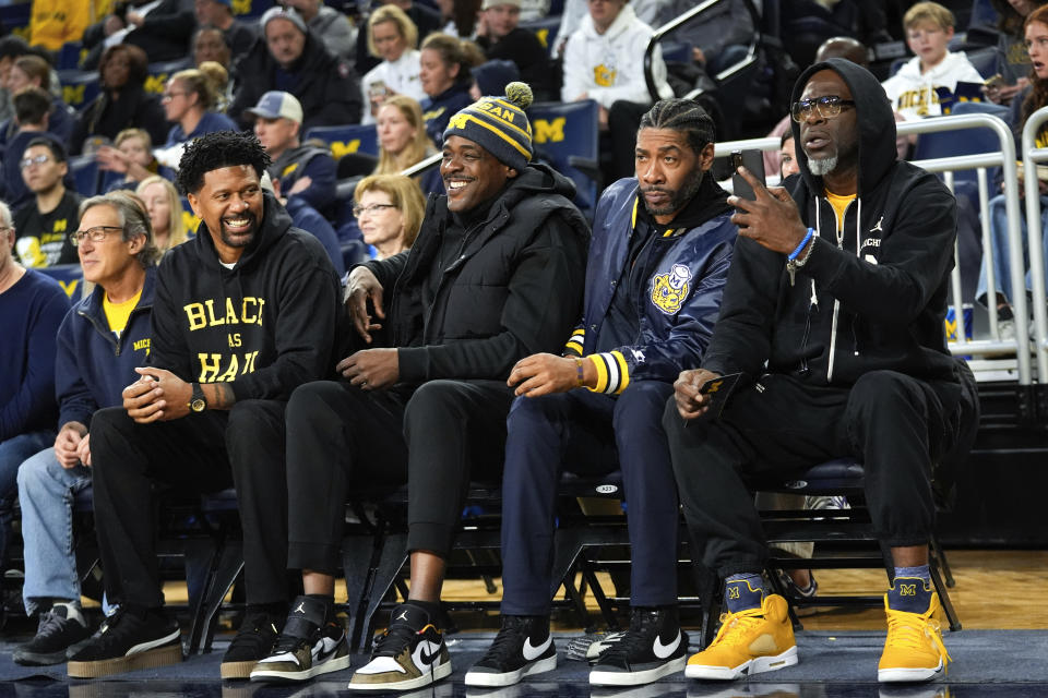 Former Fab Five Michigan basketball players Jalen Rose, from left, Chris Webber, Jimmy King and Ray Jackson watch in the first half of an NCAA college basketball game against Ohio State in Ann Arbor, Mich., Monday, Jan. 15, 2024. (AP Photo/Paul Sancya)