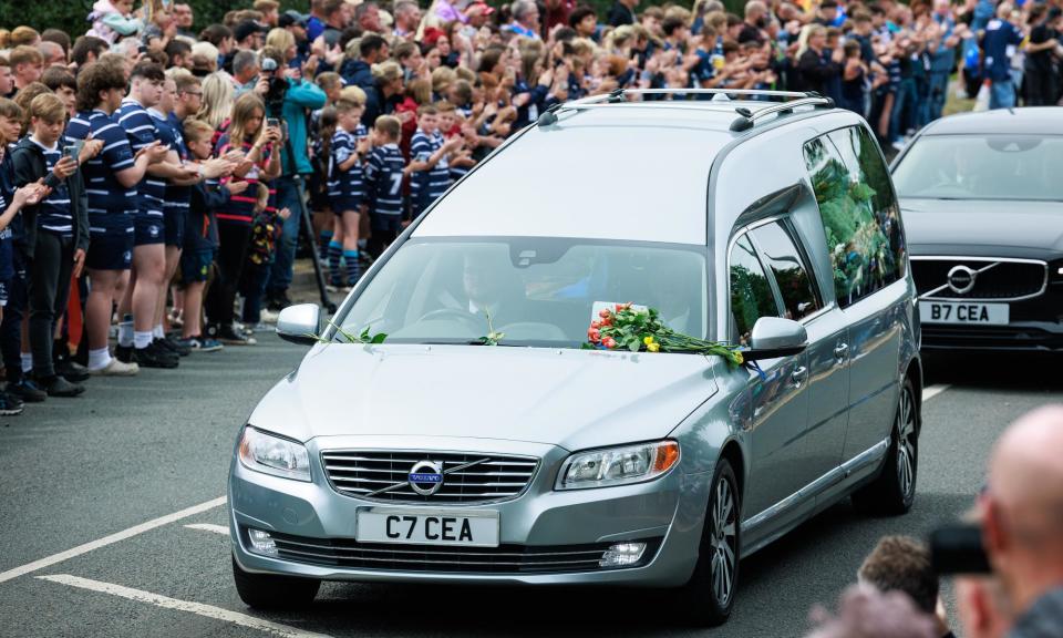 <span>Rapturous applause broke out as the hearse carrying rugby legend Rob Burrow passed by wellwishers.</span><span>Photograph: Joel Goodman/The Guardian</span>