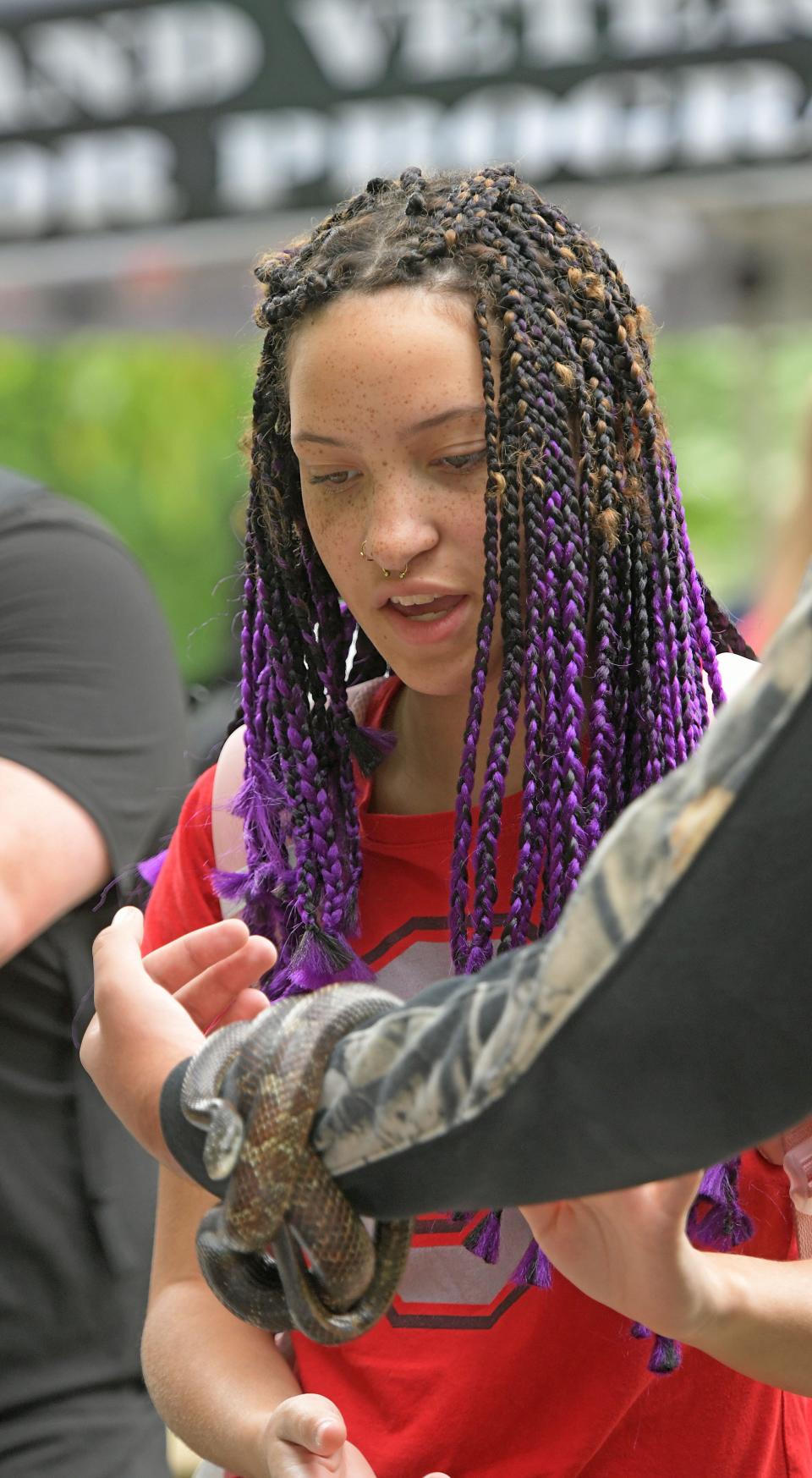 First year OSUM student Lexi Unger gets a chance to pet a snake from the Gorman Nature Center on Wednesday during the Involvement Fair for both OSU Mansfield and NCSC students.
