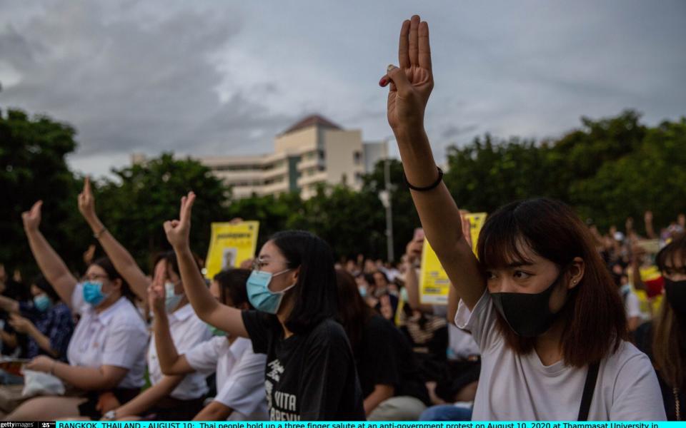 Protesters in Bangkok hold up a three-finger salute at an anti-government protest - Lauren DeCicca /Getty Images AsiaPac 