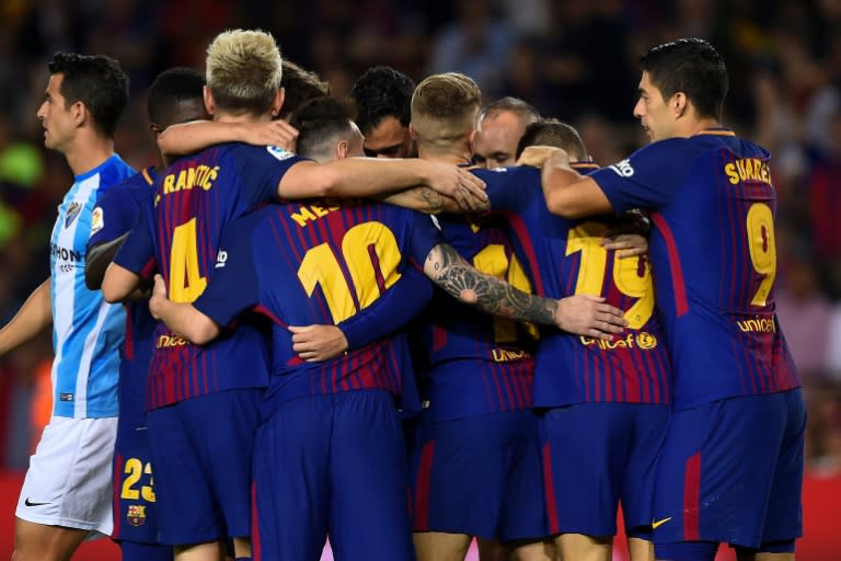 Barcelona's players celebrate a goal during their match against Malaga CFin Barcelona on October 21, 2017