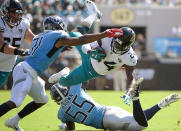 <p>Jacksonville Jaguars running back T.J. Yeldon (24) is upended by Tennessee Titans linebacker Jayon Brown (55) during the second half of an NFL football game, Sunday, Sept. 23, 2018, in Jacksonville, Fla. (AP Photo/Phelan M. Ebenhack) </p>