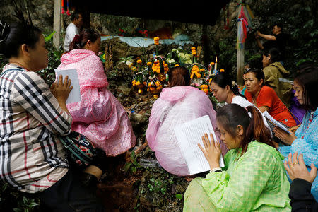 Family members pray near the Tham Luang cave complex during a search for members of an under-16 soccer team and their coach, in the northern province of Chiang Rai, Thailand, June 27, 2018. REUTERS/Soe Zeya Tun